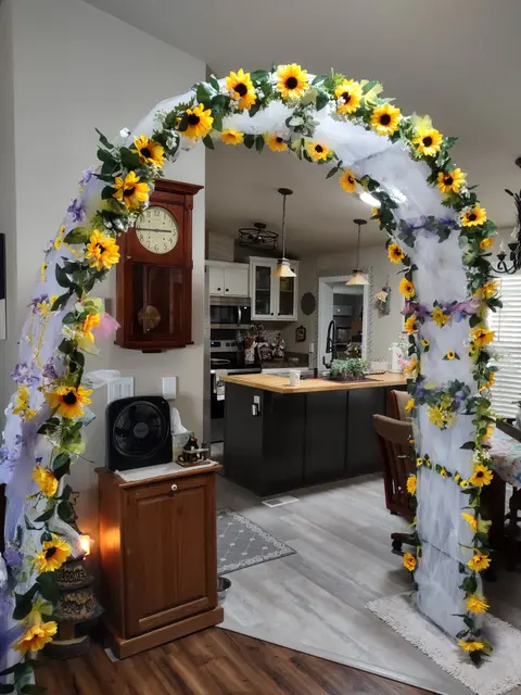 Sunflower and greenery arch for an in-home wedding